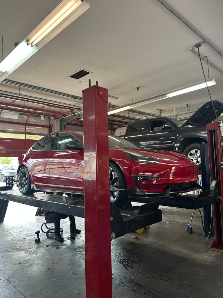 2022 Tesla 3 Performance 4-wheel alignment. Red and looks sleek.