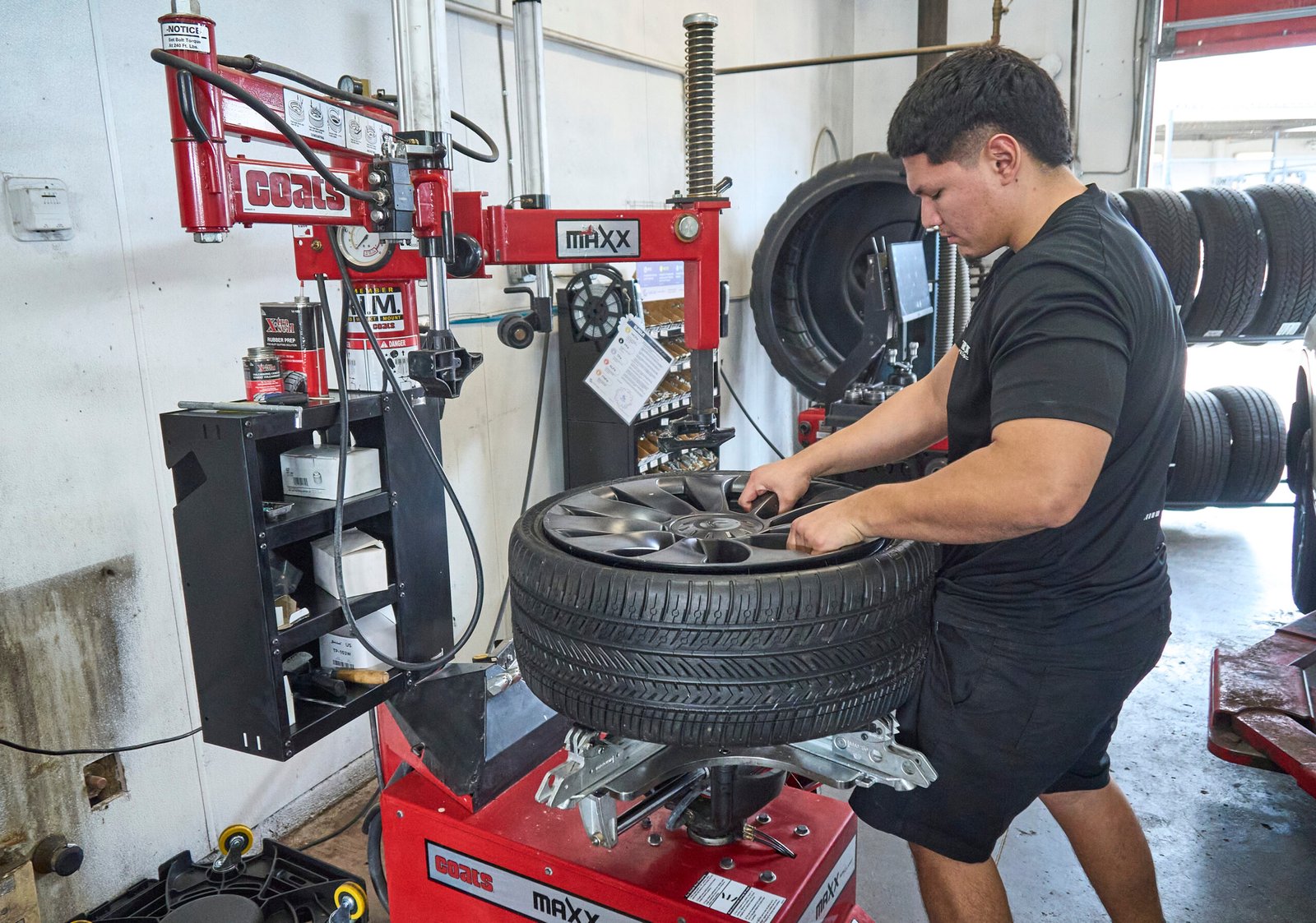 Technician mounting a Tesla tire